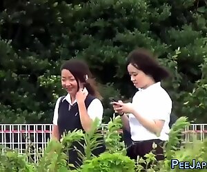 Teens in uniform peeing
