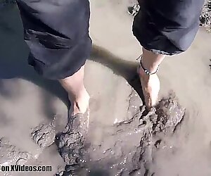 Messy foot play in a mud puddle in the forest
